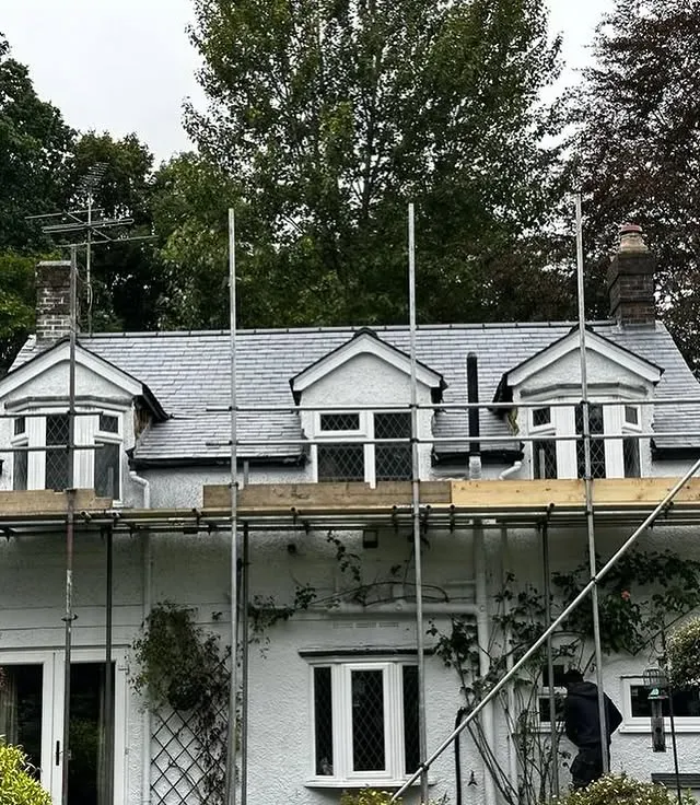 Emergency tarpaulin repair on a storm-damaged roof
